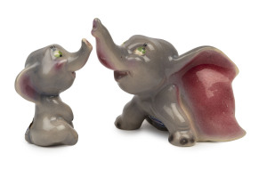 DUMBO: painted and glazed ceramic figurines (2), the larger depicting "Dumbo looking upwards", by Modern Ceramic Products (Sydney), both with MCP foil stickers intact; c. late 1940s, larger piece 11cm tall. (2)