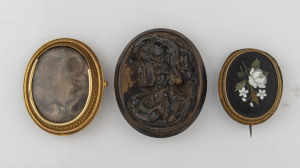 Three antique brooches including pietra dura, oval mourning and bog oak cameo, 19th century, the largest 5cm high