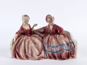 A Continental porcelain figure group of two ladies in crinoline dresses, 20cm high, 31cm wide