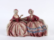 A Continental porcelain figure group of two ladies in crinoline dresses, ​20cm high, 31cm wide