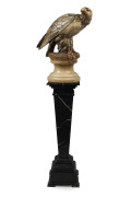 An antique carved marble and alabaster eagle statue on black marble pedestal base, late 19th century, the eagle 68cm high, 172cm high overall
