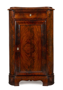 A Biedermeier corner cabinet, flame mahogany with mother of pearl escutcheon, early to mid 19th century, ​148cm high, 94cm wide, 67cm deep