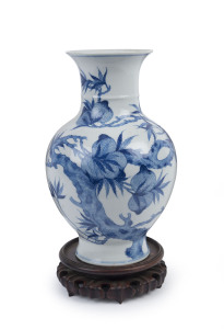 A Chinese baluster shaped blue and white porcelain vase with wooden stand, Republic period, 34cm high