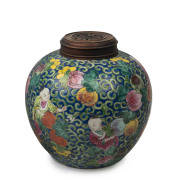 A Chinese porcelain jar with boys and fruit on blue ground with carved timber lid, Republic period, ​21cm high, 20cm wide