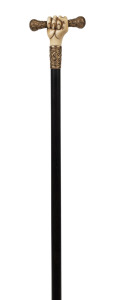 An antique walking stick with marine ivory carved fist handle, gilt metal mounts, ebony shaft and bone ferrule, 19th century, 82cm long