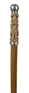 A walking stick with an eastern carved marine ivory handle, English sterling silver top, cane shaft and brass ferrule, 19th century, ​98cm high