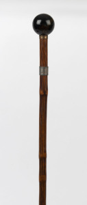 A walking stick with spherical tiger eye handle, silver and gold plated collars, cane shaft and metal ferrule, 19th century, 83cm high