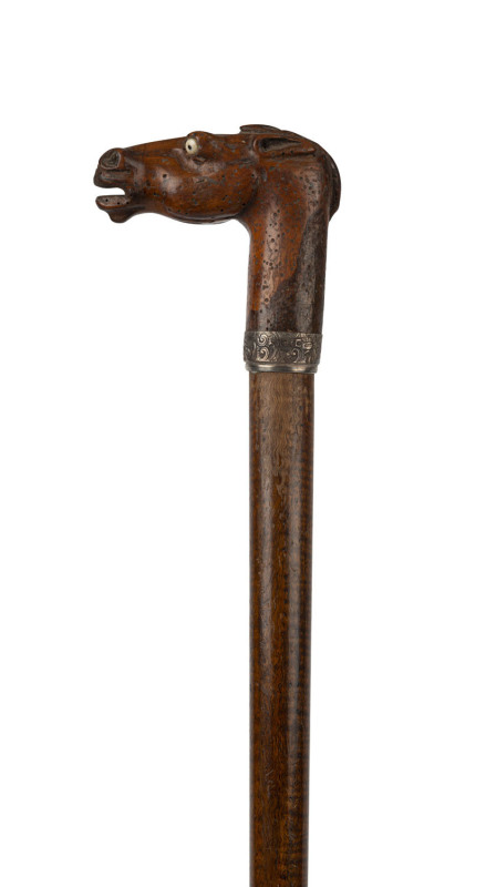 An antique walking stick with carved wooden horse head handle, ivory eyes, sterling silver collar and fiddleback shaft, 19th century, missing ferrule, 94cm long