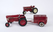 Two International diecast vintage model tractors and a vintage TONKA tinplate trailer, 20th century, ​the larger tractor 24cm long