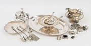 Large silver plated meat platter, toast rack, two gravy boats, three compotes, five napkin rings, assorted condiments and servers, 20th century, (24 items), the platter 52cm wide