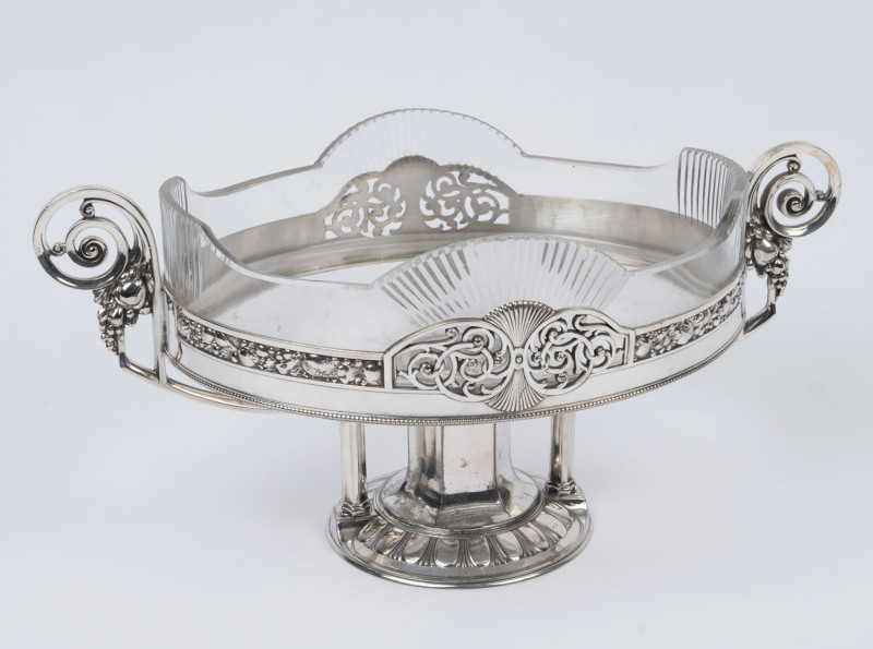 A German silver plated centre piece with original glass liner, circa 1900, ​18cm high, 36cm wide