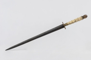 An antique German paper knife, marine ivory handle with steel blade and cast metal fittings, 19th century, ​35cm long