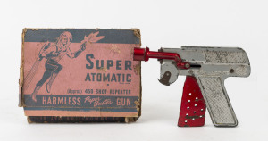 TOY GUN: "Super Atomatic" 450 shot repeater "Harmless Paper Buster Gun" in metal, by A. Padjon (Australia), original box (defective) with spaceman illustration; c.1950s, length 16cm.