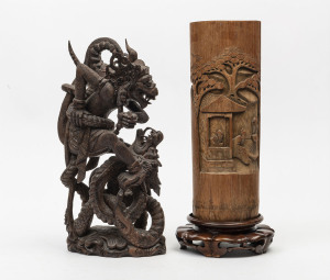 A Chinese carved bamboo brush pot on later carved wooden stand together with an Indonesian carved timber statue, 20th century, 36cm and 32cm high