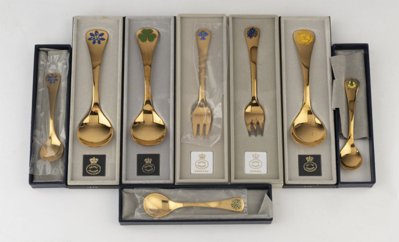 GEORG JENSEN Danish sterling silver year forks, soup spoons and teaspoons with enamel decoration and gilt finish, with original boxes and papers, near mint condition, late 20th century, (8 items), the soup spoons 15cm long, 240 grams total