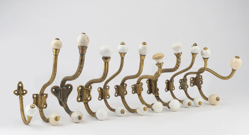 Eleven antique coat hooks, gilt metal and porcelain, 19th century, ​the largest 18cm high