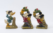 MICKEY MOUSE & DONALD DUCK: painted and glazed celluloid figurines with Mickey Mouse doffing his cap (2) in similar but not identical designs, plus Donald Duck grasping his hat and a sword; c.1930s, tallest 24cm (3).