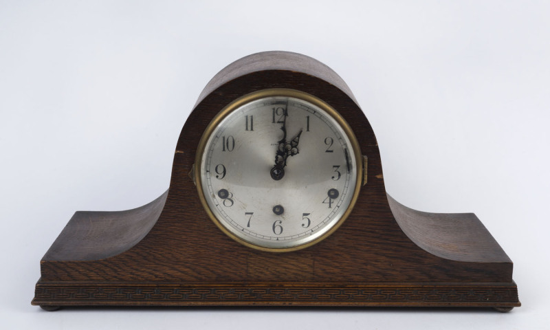 A Napoleon hat mantel clock with three train movement in oak case, circa 1920, retailed through Dunklings, Melbourne, 24cm high