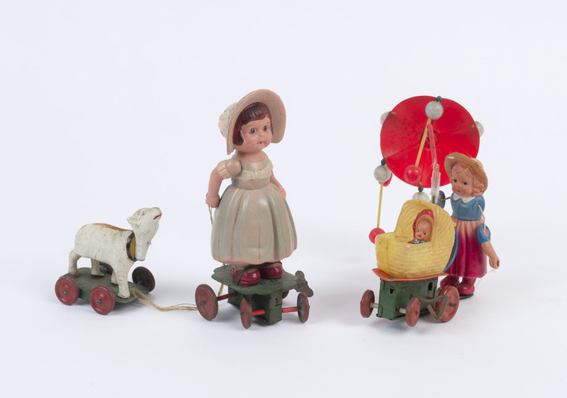 "LITTLE BO PEEP & LAMB" AND A CAROUSEL BABY CARRIAGE: celluloid and tinplate windup toys, the latter with defective umbrella pole; both made in Japan, c.1930s. (2)