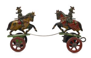 DUELLING KNIGHTS: rare wind-up lithographed tinplate toy mounted on wheels, toy moves in a to-and-fro motion when mechanism is activated; made in Germany c.1920s, length 22cm, height 13cm.