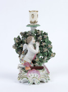 CHELSEA English porcelain figure of a young cherub kneeling on a flower encrusted base, circa 1770, later replacement candle holder, 20 cm high