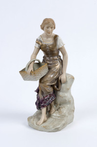 A Royal Vienna porcelain statue of a peasant girl, late 19th century, impressed "Made in Austria" with blue factory mark, ​30cm high