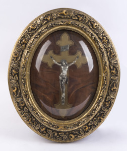 An oval framed Christ on crucifix behind convex glass, early 20th century, ​50 x 42cm