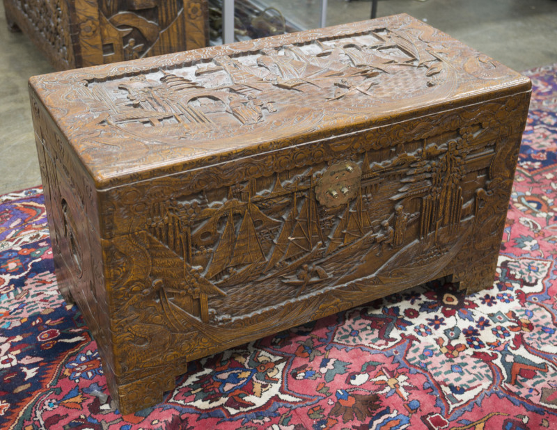 A Chinese carved camphor wood trunk, 20th century, 60cm high, 106cm wide, 52cm deep