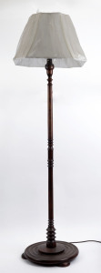 A turned timber standard lamp and shade, circa 1930s, ​178cm high