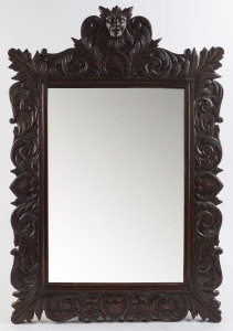 An English Gothic style mirror, ornately carved in oak, 19th century, ​92 x 61cm