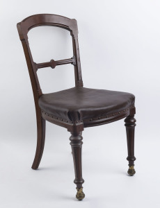 An antique English carved walnut side chair with unusual brass castors, late 19th century