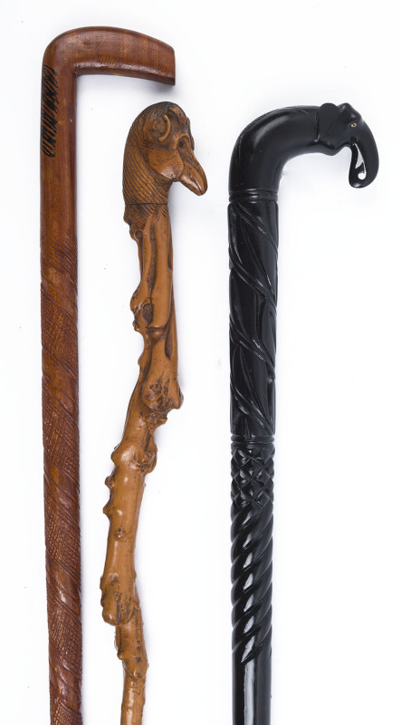 Three carved walking sticks including an Indian elephant head, blackthorn with animals head handle and a carved cross-hatched example, ​the largest 92cm high