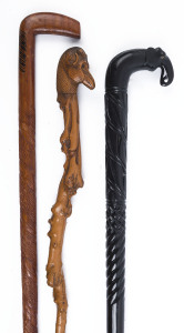 Three carved walking sticks including an Indian elephant head, blackthorn with animals head handle and a carved cross-hatched example, the largest 92cm high