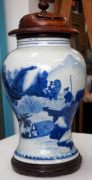 A fine Chinese baluster shaped vase with underglaze blue decoration of fishing figures in landscape, Kangxi Period, circa 1700, with carved hardwood lid and timber stand, 26cm high - 2