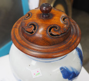 A fine Chinese baluster shaped vase with underglaze blue decoration of fishing figures in landscape, Kangxi Period, circa 1700, with carved hardwood lid and timber stand, 26cm high - 6