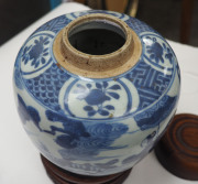 A Chinese ovoid porcelain jar, underglaze blue decoration with figures and donkey in landscape, Ming Dynasty, circa 1500, with accompanying finely carved wooden stand and lid, ​23cm high overall - 9