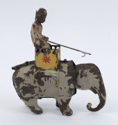 Tinplate toy selection comprising Louis Marx (USA) wind-up "Golden Goose"; Stollwerck Bros candy "Liliputian Savings Bank" candy store; unusual "buckets on a pulley" wheel-driven toy, plus wind-up "Mahout riding Elephant" with rearing motion when activate - 3