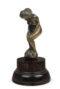 A cast bronze female nude car mascot on later wooden base, circa 1920s, 19cm high overall