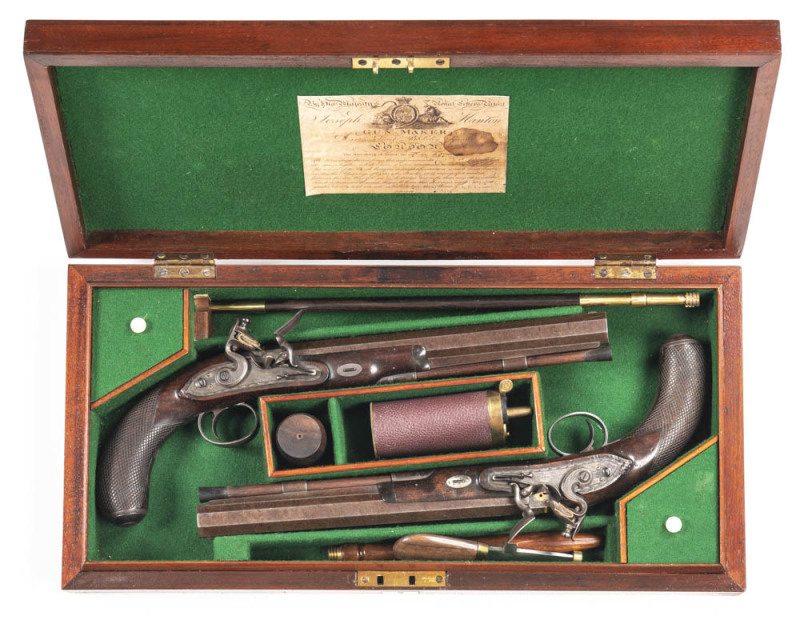 CASED PAIR OF JOSEPH MANTON FLINTLOCK HALF STOCKED DUELLING PISTOLS: 50 Cal; 10" octagonal barrels with small areas of light bruising & one pistol has light vice marks to the breech; g. bores; small silver blade front sights & notched rear sights at the t