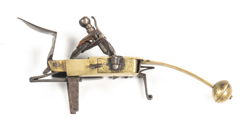 ENGLISH BRASS BODIED FLINTLOCK TINDER LIGHTER: game bird & foliage to frame; fitted with a swan necked style cock, external main spring & fittings including a small fitted bi-pod stand; mellow patina to brass body; all complete; gwo & cond. C.1800 N/