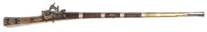 TURKISH MIQUELET RIFLE: 50 bore; 37½" octagonal figured twist barrel with flared muzzle, touch marks to breech; g. bore, rifled with 7 grooves, large tang sight with 5 peep holes; standard lock with some decoration in relief; ball trigger; mottled grey fi