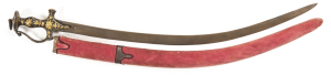 INDIAN TULWAH: vg curved, watered blade with a hole at the ricasso; faint central grooves; cast hilt of traditional form, chased with gold flowers & leaves against stippled black background; complete with faded red velvet scabbard with brass mounts. A vg