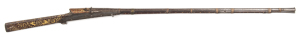 INDIAN MATCHLOCK GUN: 16 bore; 44" round Damascus barrel with flared muzzle, entire exposed metal with scenes in relief of large game animals; standard serpentine type lock; side plates of polished steel with faded gilt border design; light brown Damasc