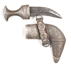 VERY GOOD OMANI SILVER MOUNTED JAMBIYA: g. 6½" double edged blade with a raised central rib; embossed silver hilt & pommel with giraffe ossicone hilt; complete with embossed silver fittings to scabbard with green velvet backing; all complete; vg cond. 