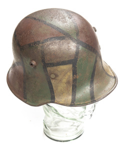 GERMAN WW1 MODEL 16 OR'S STEEL FIELD HELMET: complete with partial leather liner & metal band; replaced chin strap; with an o/all camouflage finish, thinning in various sections; o/all g. cond,