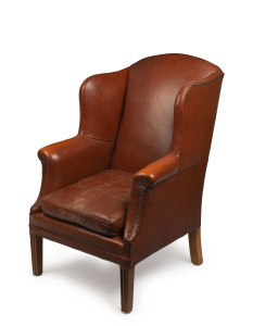 A brown leather wingback armchair, 20th century, 109cm high, 75cm across the arms