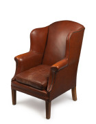 A brown leather wingback armchair, 20th century, ​109cm high, 75cm across the arms