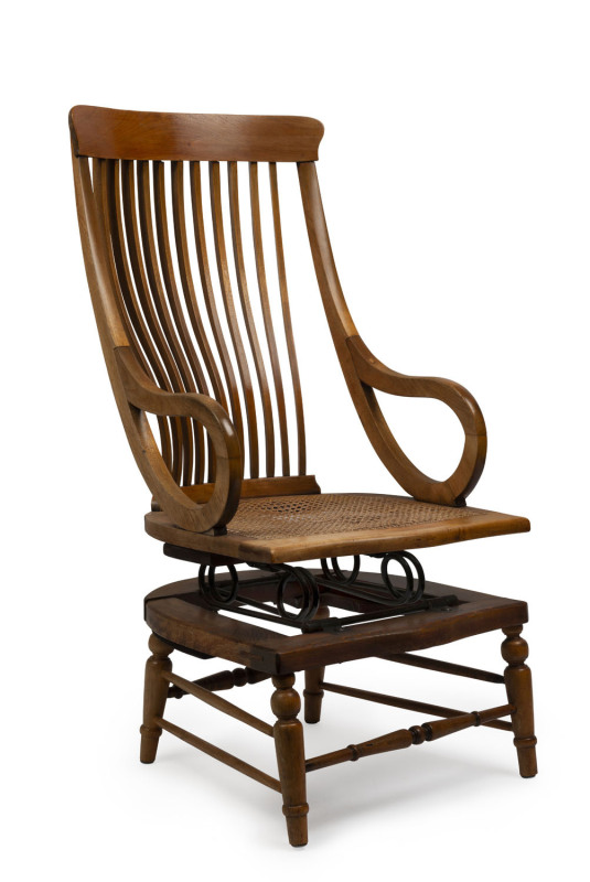 An unusual antique platform rocking chair with rattan seat, 115cm high, 55cm across the arms