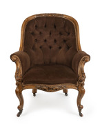 An antique English armchair, carved walnut with brown velvet upholstery, circa 1870, 103cm high, 77cm across the arms