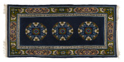 A Chinese hand-woven rug with three medallions on blue background, 20th century, ​ 190 x 90cm